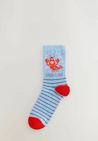 Light blue sock featuring horizontal navy stripes, red toes and heel, with a cartoon lobster design and the text "SANTA CLAWS" beneath.