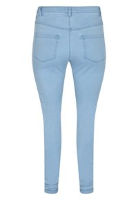 Jeans ajustados de mezclilla en azul claro, con diseño de cinco bolsillos y detalles de costura. Textura suave con una Silueta ceñida.