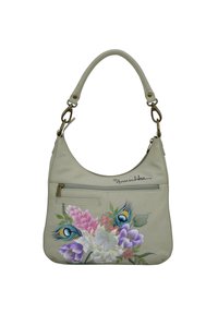 Lichtbeige leren handtas met een gebogen vorm, bloemenschildering in roze, paars en blauw; heeft een voorste ritsvak en een schouderband.