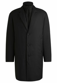 Cappotto nero e leggero con un design strutturato. Presenta un collo a revers, tre bottoni e tasche laterali. Tessuto liscio e opaco.