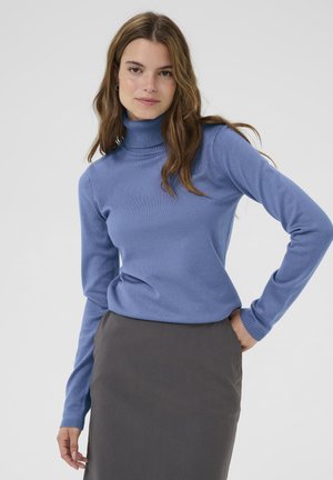 Light blue turtleneck sweater made of soft fabric, featuring a ribbed collar and cuffs. Paired with a dark gray skirt, fitted design.