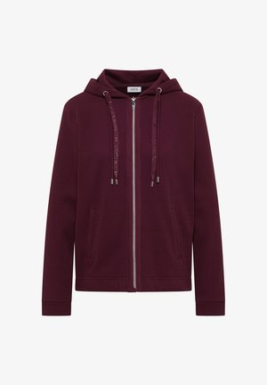 Veste à capuche zippée couleur bordeaux avec tissu texturé, poches avant, cordons de serrage et fermeture éclair argentée visible.