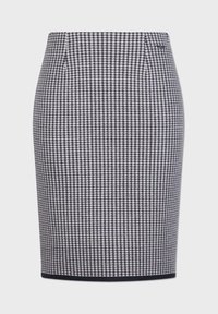 Kostymkjol med hundtandsmönster, marinblå och vit, figurnära design, texturerad tyg, midjeband och svart kantdetalj.