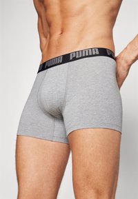 Gray cotton boxer briefs featuring a black waistband with white "PUMA" lettering. Smooth texture and fitted design.