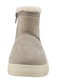 Beige enkelboots met een suède-achtige textuur, voorzien van een witte nepbontkraag, een zijrits, gestikte details en een chunky witte zool.