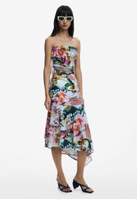 Strapless floral dress with layered, asymmetrical hem; vibrant colors, featuring orchids and tropical patterns; lightweight fabric, ruffled design.