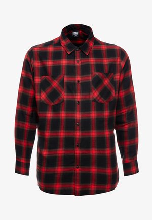 Red and black checked flannel shirt with long sleeves, two chest pockets, and button-down front. Soft, textured fabric with a classic pattern.