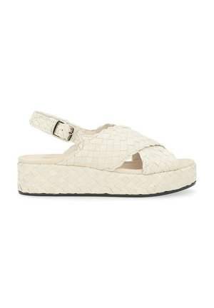 Sandali platform intrecciati in crema, con design a strap incrociati, punte aperte, cinturino alla caviglia regolabile e suola testurizzata di 3,5 cm.