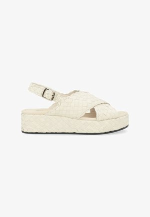 Sandali platform intrecciati in crema, con design a strap incrociati, punte aperte, cinturino alla caviglia regolabile e suola testurizzata di 3,5 cm.