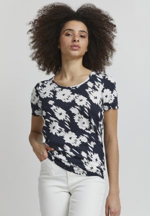 T-shirt bleu marine avec motif floral blanc, manches courtes, col rond et coupe décontractée. Le tissu semble doux et léger.