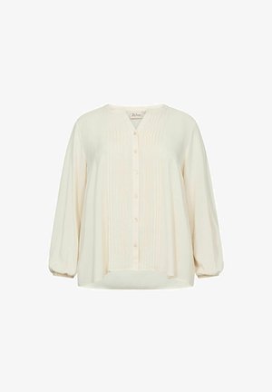 Krém színű blúz gombos elülső résszel, függőleges pliszékkel és ballon ujjakkal. Puha, könnyű anyaga kényelmes szabást biztosít.