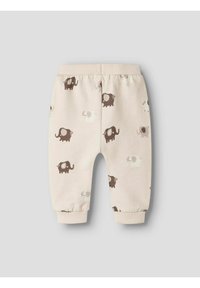 Beige Hosen für Kleinkinder mit einem elastischen Bund, die verschiedene Elefantenmuster in Braun und Weiß aufweisen. Bündchen an den Knöcheln für eine optimale Passform.
