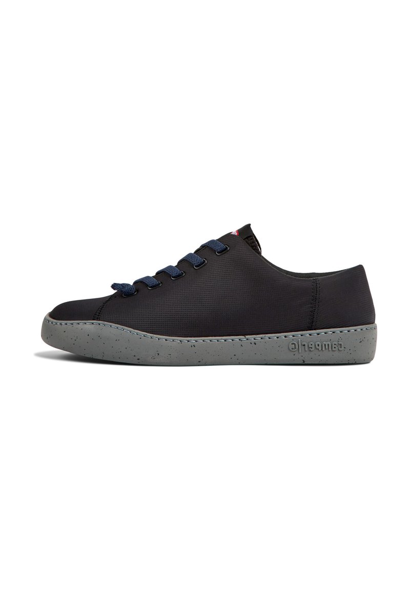 Black sneaker with a textured upper, featuring blue laces, a speckled gray sole, and contrasting stitching along the edges.