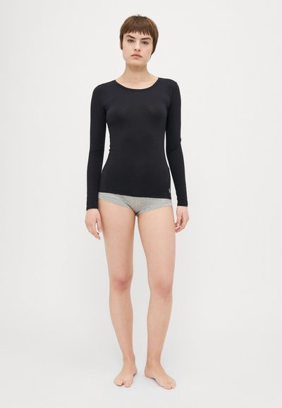 Black long-sleeve top made of stretchy material, fitted design, round neckline. Paired with light gray low-rise shorts, minimalistic style.