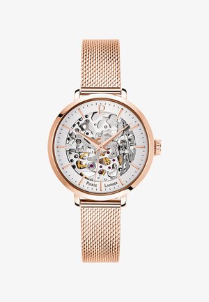Gouden meshband horloge met een transparante skeleton wijzerplaat die ingewikkelde tandmechanismen onthult, verfraaid met zilveren en roze details.