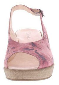 Pink leather sandal with cutout design and ankle strap, featuring a textured beige sole and subtle floral pattern on the upper.