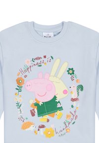 Sweatshirt bleu clair avec des personnages de dessin animé : un cochon rose et un lapin crème, entourés de fleurs colorées et du texte "Le bonheur est fait main."