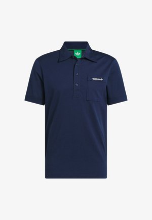 Navy blue polo shirt made of cotton. Features a collar, three buttons, a patch pocket, and an embroidered logo on the chest. Green tag inside.
