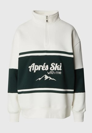 Bílá a tmavozelená mikina s krátkým zipem vyrobená z měkkého materiálu, s výšivkou "Aprés Ski with me" a horským motivem, doplněná o pruhované detaily.