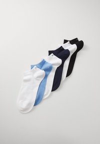 Set of six ankle socks in white, light blue, navy, and black, featuring a smooth texture with ribbed cuffs and subtle branding on the top.