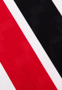 Textiel met drie gedurfde strepen: rood, zwart en wit. Gladde textuur met subtiele patronen, wat een levendig contrast tussen de kleuren biedt.