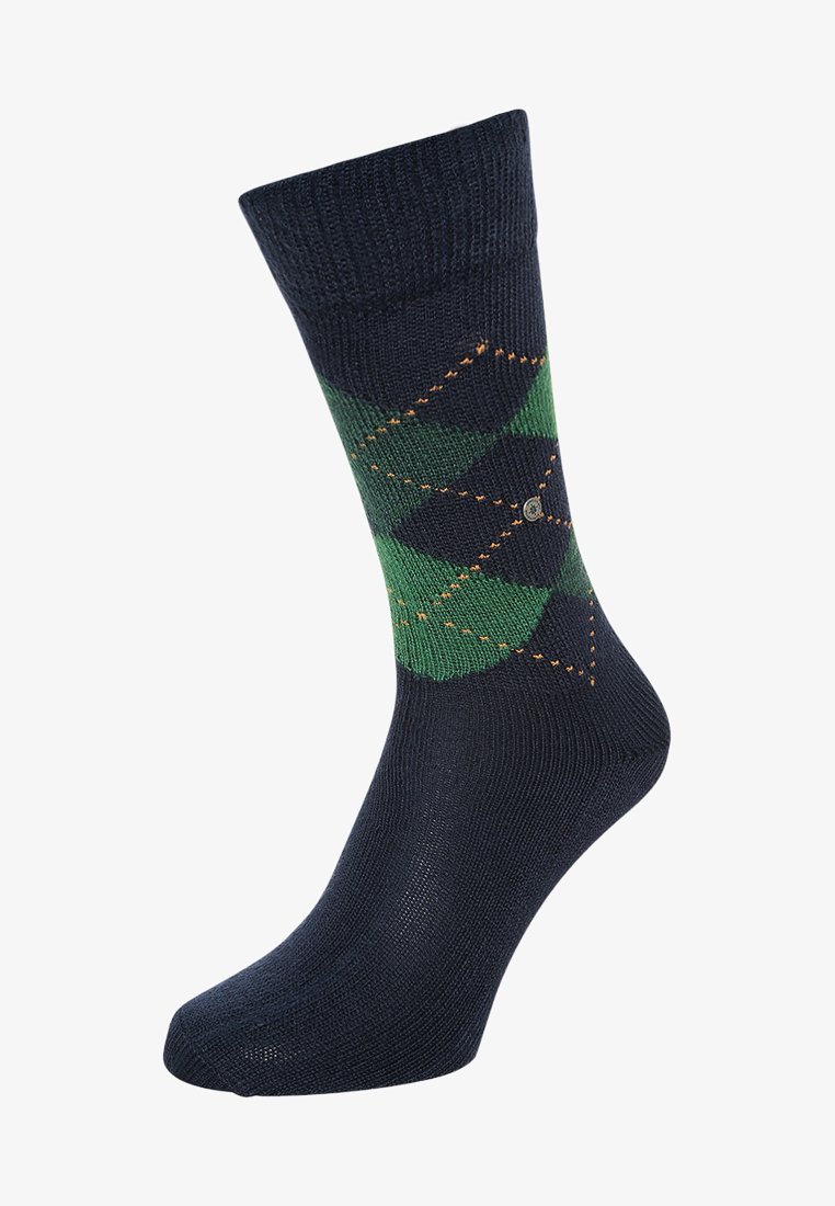 Calcetines azul marino con patrón de argyle verde, acentos de costura naranja y puño acanalado. Fabricados con un material suave y elástico para mayor comodidad.
