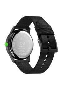 Black solar-powered watch with a round stainless steel case, featuring a green crown and a woven black strap. Back has engraved details.