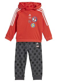 Felpa rossa con cappuccio e strisce bianche, decorata con grafiche Marvel, abbinata a pantaloni grigi con icone circolari nere dei supereroi.