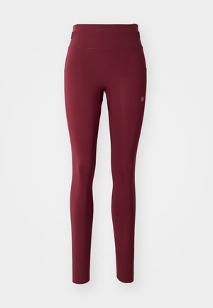 High-waisted burgundy leggings with a small circular logo on the upper thigh, displayed on a plain white background.