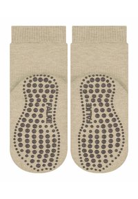 Beżowe skarpetki bawełniane o teksturowanej powierzchni i gumowym wzorze w kropki zapewniającym przyczepność. Na pięcie wytłoczona marka "FALKE". Zaprojektowane do użytku antypoślizgowego.