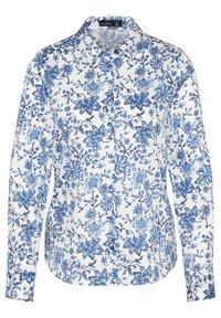 Valkoinen pitkähihaiseksi napitettu paita, jossa on sininen kukkakuosi ja terävä kaulus.