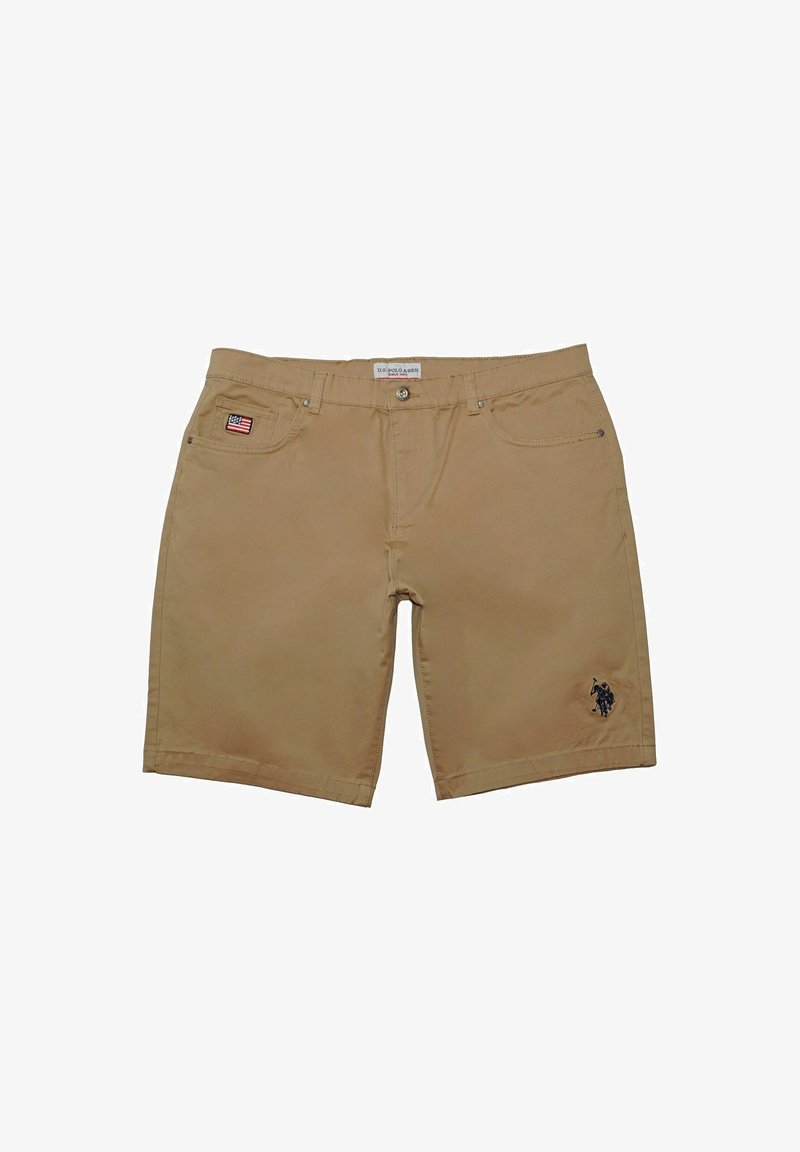Tan shorts made of cotton with a straight cut. Features a small American flag patch on the left pocket and an embroidered logo on the right leg.