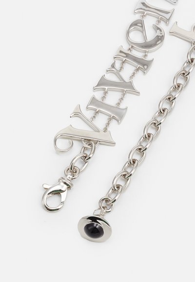 Silver chain bracelet with large letter accents, shiny finish, and a lobster clasp. Features a circular black detail at the end.