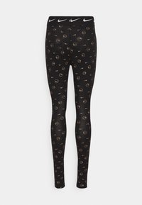 Černé legíny se zlatými kruhovými vzory a logy Nike. Mají černý pas se bílým brandingem Nike. Hladká textura, úzký střih.