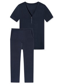 T-shirt bleu marine avec décolleté en V et patte de boutonnage à cinq boutons, associé à un pantalon slim assorti avec poches latérales et une texture douce.
