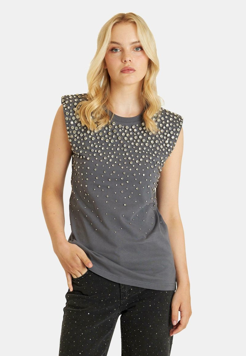 Gray sleeveless top featuring a round neck and embellished with silver studs in a varying pattern across the shoulders and chest.