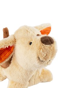 Plush toy dog with beige fur, brown accents, and textured orange ears featuring polka dots. It has a smiling face and round snout.