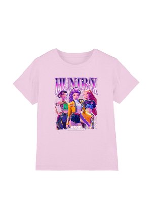 Pink cotton T-shirt featuring an animated graphic of three characters with the text "HUNTRAX" in bold, colorful lettering.
