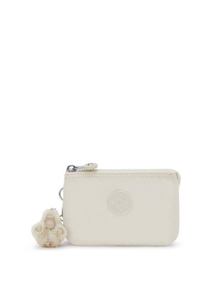 Zip wallet in cream fabric with embossed logo, featuring a plush charm attached. Compact rectangular shape with stitched detailing.
