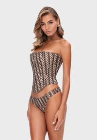 Bikini bez ramiączek w kolorze nude z czarnymi, falującymi wzorami. Materiał wygląda na gładki, z dopasowanym krojem i bocznymi wycięciami.