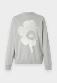 Sudadera gris de algodón, con un gran gráfico de una flor blanca con un centro circular. Mangas largas y puños acanalados.