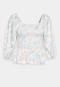 Top peplum floral com mangas bufantes. Feito de tecido leve, apresenta um corpete franzido em padrões de rosa pastel, azul e amarelo. Decote quadrado.