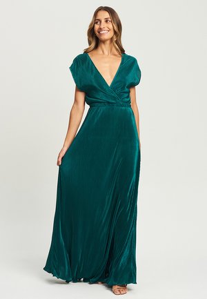 Robe maxi plissée teal avec des manches courtes, décolleté en V profond et taille ajustée. Tissu doux et texturé tombant jusqu'au sol.