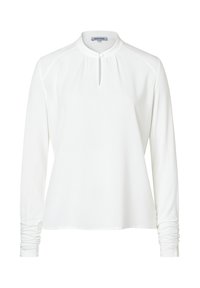 White long-sleeve shirt with a banded collar, keyhole neckline, and gathered sleeve details. Smooth fabric, relaxed fit, and minimal design.