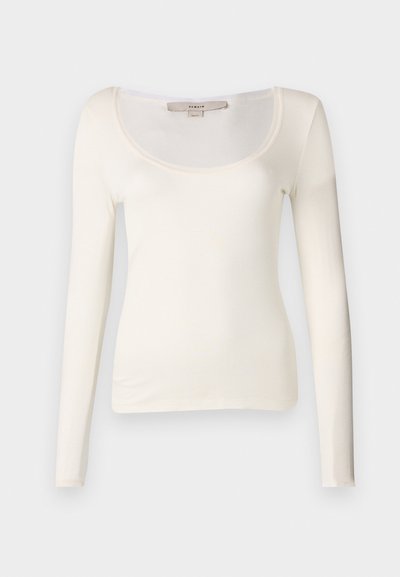 Long-sleeve, cream-colored fitted top with a scoop neckline and ribbed texture. Fabric appears soft and stretchy, ideal for layering.