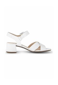 Sandale blanche en cuir à bout ouvert avec talon bloc, bride ajustable à la cheville et deux larges sangles croisées sur le devant du pied.