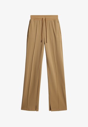 Lichtbruine, gestructureerde, wijde pantalon met een koord in de taille en zijopeningen. Bevat subtiele branding.