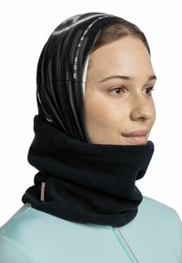Cuello polar negro con una parte superior de textura impresa en tonos de negro y blanco, que presenta elementos de texto gráfico.