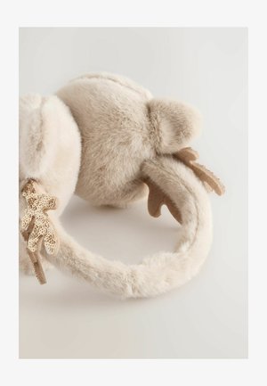 Cache-oreilles en fausse fourrure de couleur beige clair avec une texture douce, présentant un accent en cuir en forme de cornes. Design arrondi et moelleux.