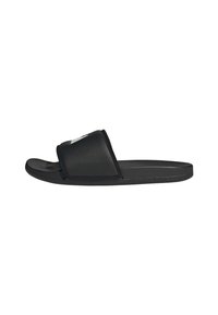 Black slide sandals made of perforated synthetic material. Features a wide strap and a smooth sole for comfort and stability.